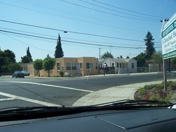 Alameda apartment for rent - a building on the corner of a city street with a cross walk