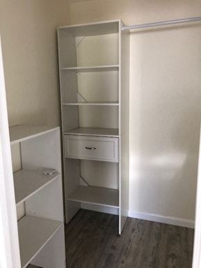 Alameda apartment for rent - A white shelving unit with a drawer is in a room with white walls.