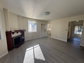 Alameda apartment for rent - A living room with a fireplace and a grey floor.