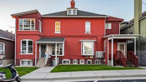 Salt Lake City apartment for rent - Front exterior of red First Avenue Homes with a view of the front yard