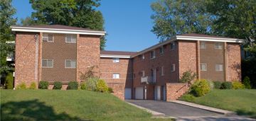 Cincinnati apartment for rent - A large red brick building with a driveway in front.