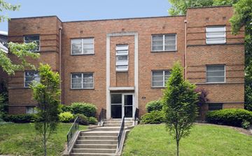 Cincinnati apartment for rent - A red brick building with a white door and windows.