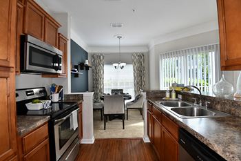 Stainless steel appliance package includes built-in microwave, glass-top range, dishwasher and refrigerator