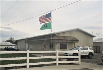 Yakima apartment for rent - A building with an American flag and a green flag on top of it.