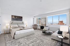 New York apartment for rent - a white bedroom with a large bed and a large window