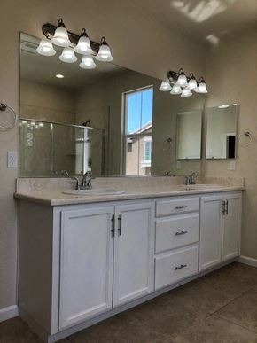 Modesto house for rent - a bathroom with two sinks and a large mirror