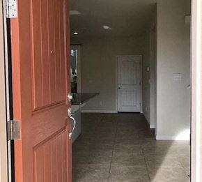 Modesto house for rent - a hallway with a red door  and a white door