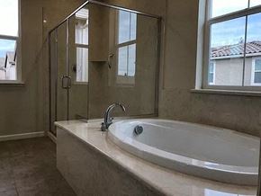Modesto house for rent - a bathroom with a large tub and a shower
