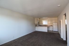 Alameda apartment for rent - A spacious living area with a kitchen in the background.