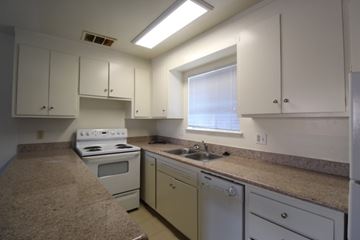 Alameda apartment for rent - A kitchen with white cabinets and a window.