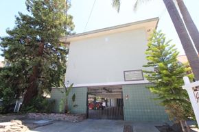 Alameda apartment for rent - A white building with a green tiled wall and a sign that says "Café".