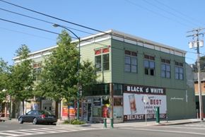 Alameda apartment for rent - A car is parked on the street in front of a Black & White restaurant.