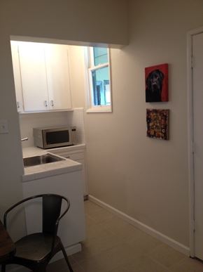 Alameda apartment for rent - A kitchen with a chair and a painting of a dog on the wall.