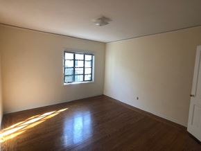 Alameda apartment for rent - an empty room with a window and wooden floors
