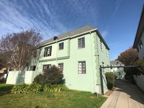 Alameda apartment for rent - a green house with a sidewalk in front of it