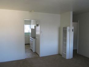 Alameda apartment for rent - A white room with a kitchen in the background.