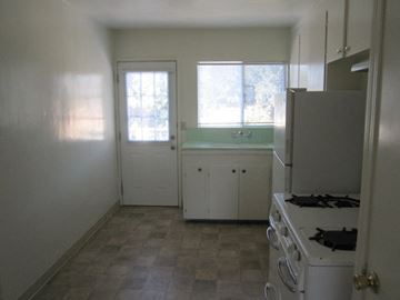 Alameda apartment for rent - A kitchen with white appliances and cabinets.