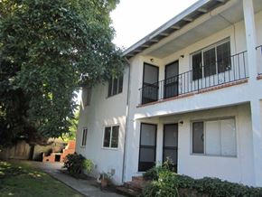 Alameda apartment for rent - A white house with a black iron railing on the balcony.