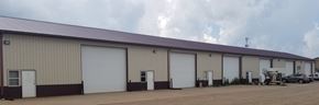 Hartford apartment for rent - A large industrial building with a row of white garage doors.