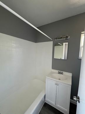 Cincinnati apartment for rent - A white sink in a bathroom with a grey wall.