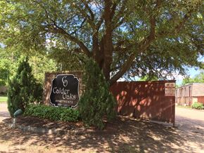 Beaumont apartment for rent - a sign oaks apartments in front of a tree