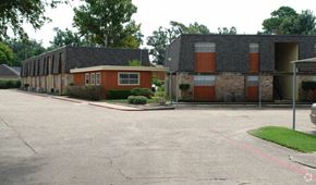 Beaumont apartment for rent - an empty parking lot in front of a building
