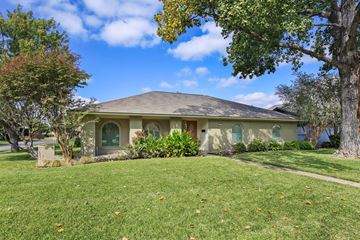Richardson apartment for rent - A house with a green lawn and trees in front.