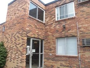 Cincinnati apartment for rent - A brick building with a door and windows.