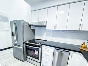 Toronto apartment for rent - A modern kitchen with a stainless steel refrigerator and oven.