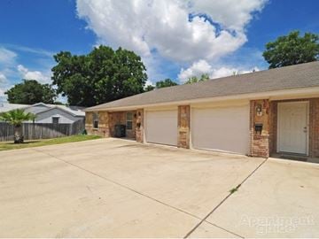 Killeen apartment for rent - a brick house with a driveway and a garage door