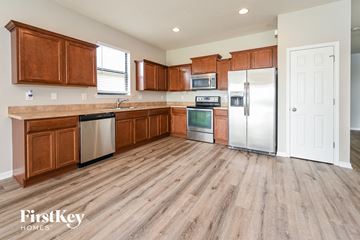 Parrish house for rent - a kitchen with wooden cabinets and stainless steel appliances