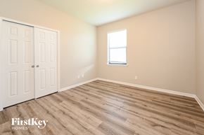 Parrish house for rent - the upstairs bedroom with wood flooring and a window