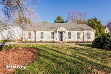 Charlotte house for rent - a white house with a lawn and a tree