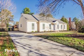 Charlotte house for rent - a white house with a sidewalk in front of it