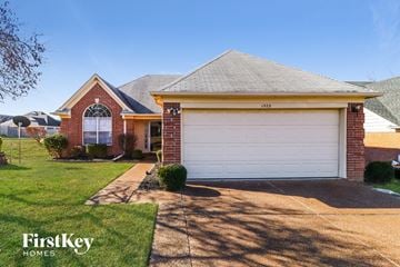 Cordova house for rent - a home with a white garage door and a lawn