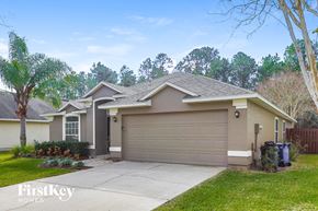 St Augustine house for rent - A house with a brown garage door is for sale.