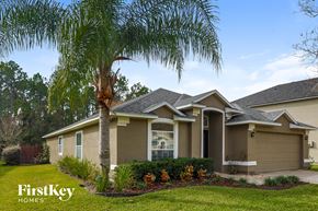 St Augustine house for rent - A house with a palm tree in front of it.