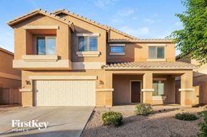 Surprise house for rent - a house with a garage door in front of it