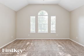 Humble house for rent - the second bedroom with carpet and three windows
