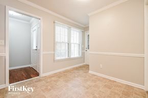 Conyers house for rent - the living room and dining room with a door to the hallway