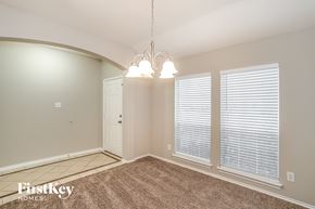 Humble house for rent - A room with a carpeted floor, a door, and a window with blinds.