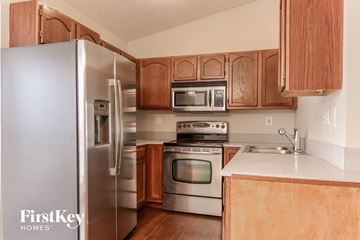 Arnold house for rent - A kitchen with wooden cabinets and stainless steel appliances.