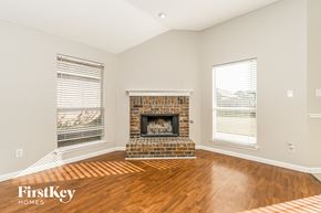 Midlothian house for rent - A living room with a fireplace and wooden floors.