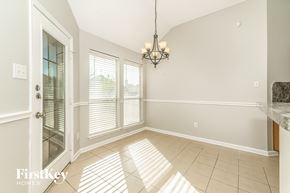 Midlothian house for rent - A sunny room with a chandelier hanging from the ceiling.