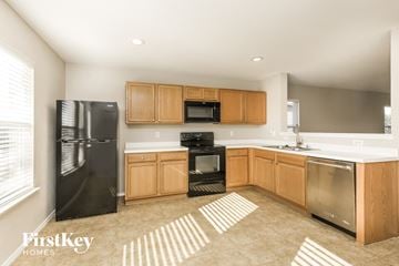 Denton house for rent - A kitchen with wooden cabinets and stainless steel appliances.