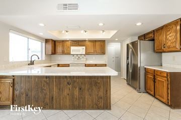Glendale house for rent - A kitchen with wooden cabinets and a white countertop.