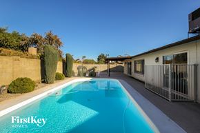 Glendale house for rent - A swimming pool in a backyard with a FirstKey Homes logo.