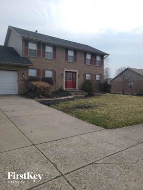 Hamilton house for rent - a brick house with a red door and a sidewalk