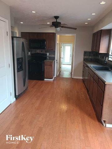 Hamilton house for rent - a kitchen with a wood floor and a stainless steel refrigerator