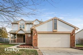 Indianapolis house for rent - A house with a garage and a brick pillar in front of it.